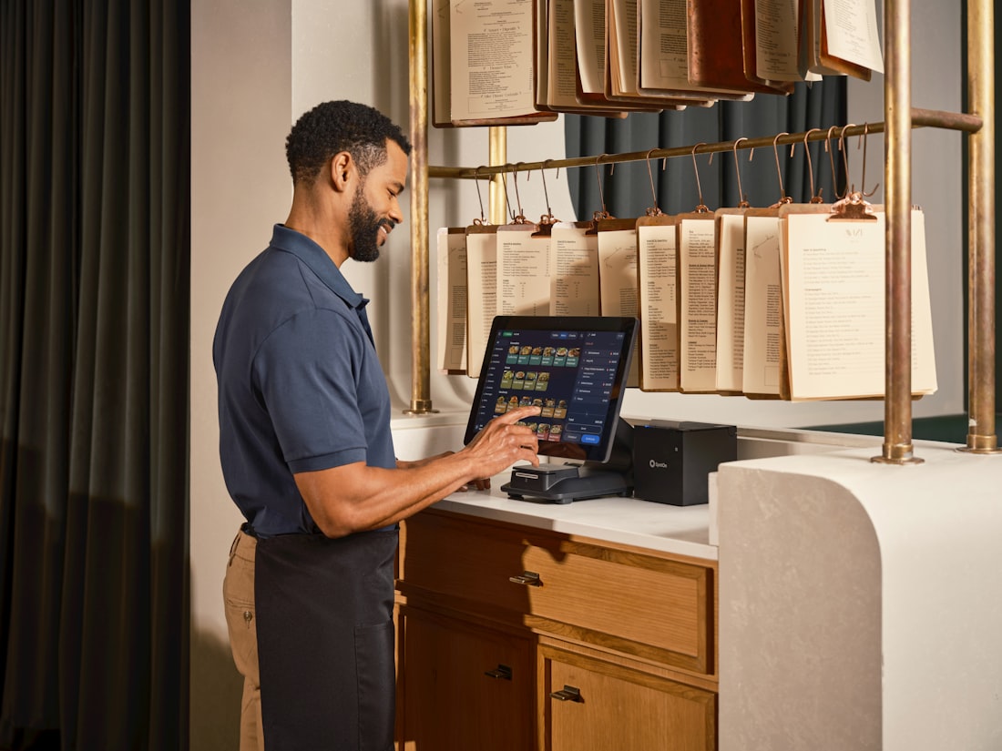 Restaurant staff taking an order on a tablet POS system